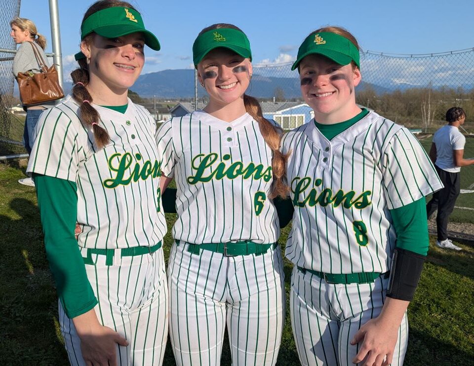 Softball Girls playing softball on a sunny field.